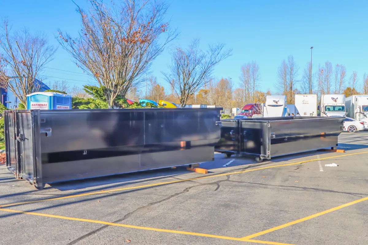 Professional dumpster rental service with roll-off container on residential driveway in DeFuniak Springs